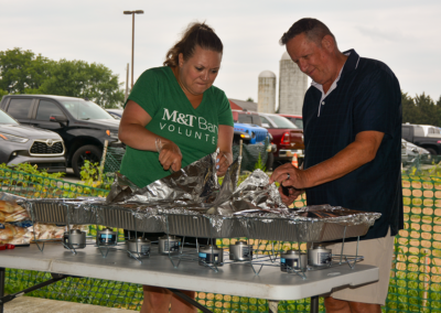 CASA board member and team member from sponsor M&T Bank serve lunch at the 4th Annual CASA of Western Maryland Golf Tournament in August 2026 at Black Rock Golf Course.