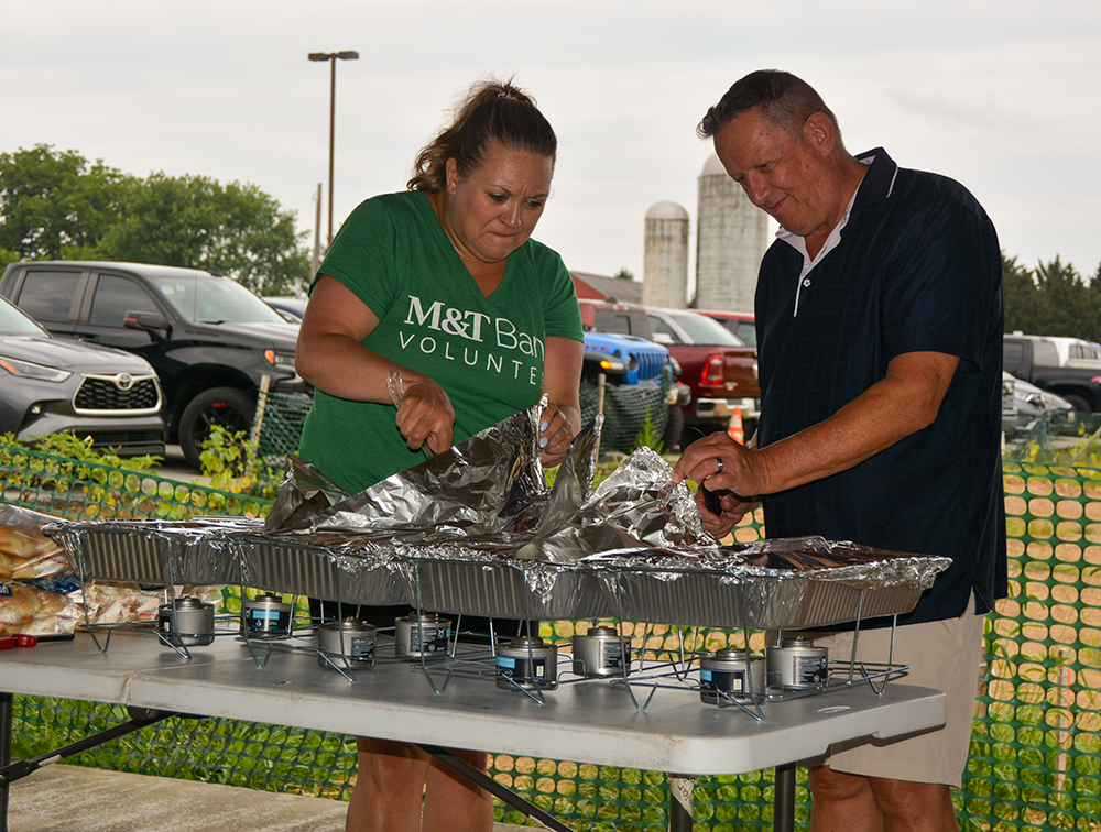 CASA board member and team member from sponsor M&T Bank serve lunch at the 4th Annual CASA of Western Maryland Golf Tournament in August 2026 at Black Rock Golf Course.