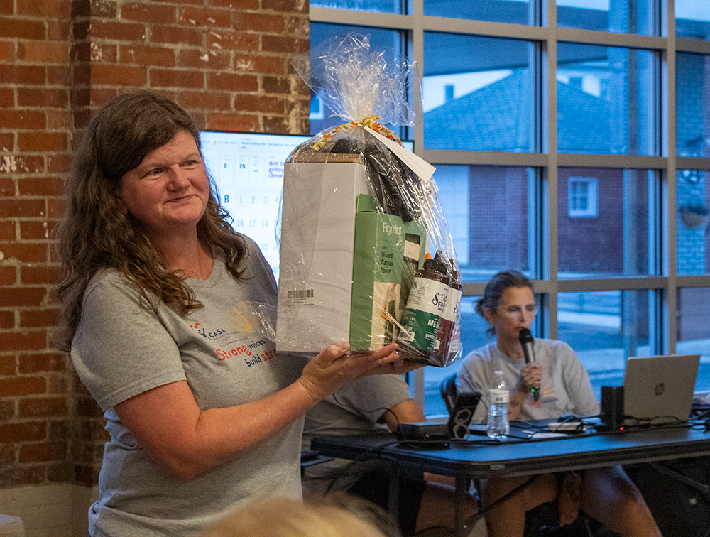 CASA of Western Maryland executive director holds prize basket at the CASA of Western Maryland 2nd Annual Fall Bingo Blitz in October 2026.